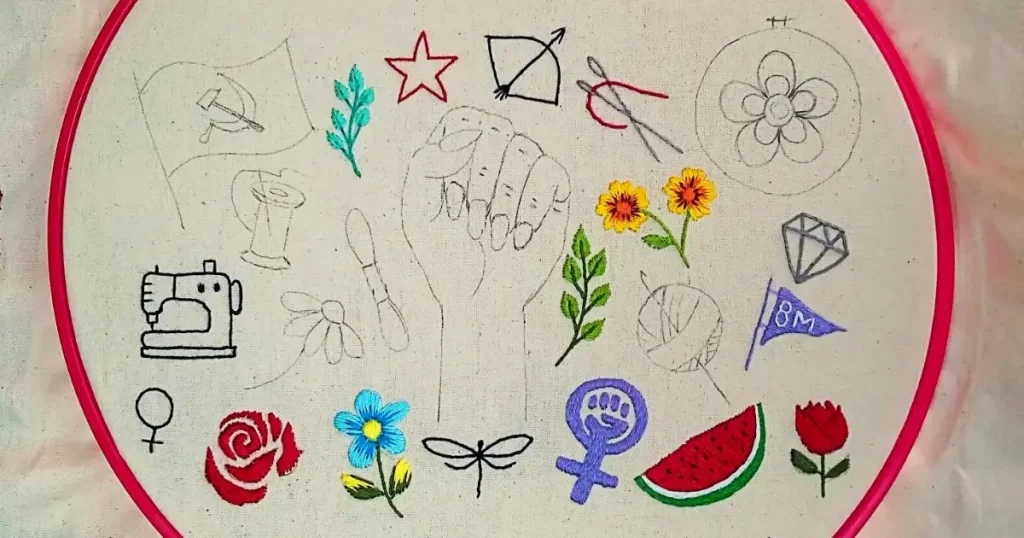 elementos bordados à mão para um banner do manifesto bordado do site agulhas da resistência da artesã andrea catão. são flores e folhas bordadas, além de símbolo feminista, uma máquina de costura, arci e flecha, agulhas e linha