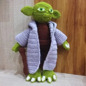 boneco mestre yoda de star wars produzido em crochê (amigurumi) pela artesã andrea catão. a imagem exemplifica a arte real no texto "Pinterest, não bote IA no meu artesanato" sobre uso de imagens de inteligência artificial como se tivessem sido produzidas por mãos humanas. texto de andrea catão para o site agulhas da resistência