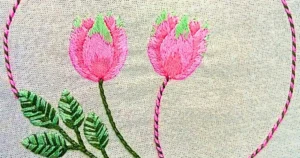 bordado à mão de arranjo de tulipas em ponto matiz e ponto pirulito em tecido de algodão. trabalho da artesã andrea catão para o canal rosália rosarinha bordado